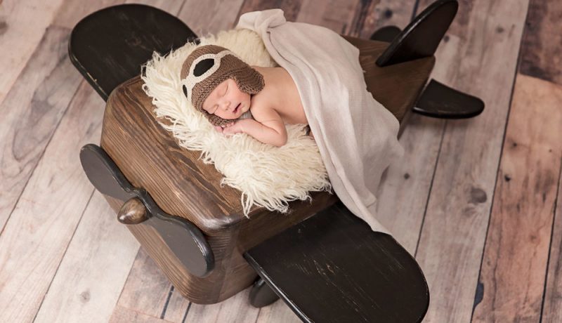 newborn photo prop - baby lay down on wood airplane